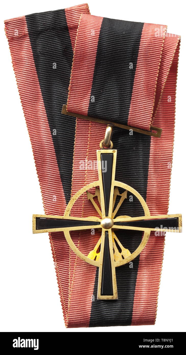 Imperial Order of the Yoke and Arrows (Orden Imperial del Yugo y las Flechas) Commander's Cross (Encomienda Sencilla) of 1943 with statutes of this highest Spanish merit order under General Franco. The black cross of the order with inset onyx stones, the mounting and ribbon clasp of gilt silver and punched with '5Z' and a five-rayed star. The symbol of the Falange Espanola is of translucent red enamel, and the yoke bears the motto of the order 'CAESARIS CAESARI DEI DEO' (tr. Render unto the emperor what is the emperor's and unto God what is God's, Additional-Rights-Clearance-Info-Not-Available Stock Photo