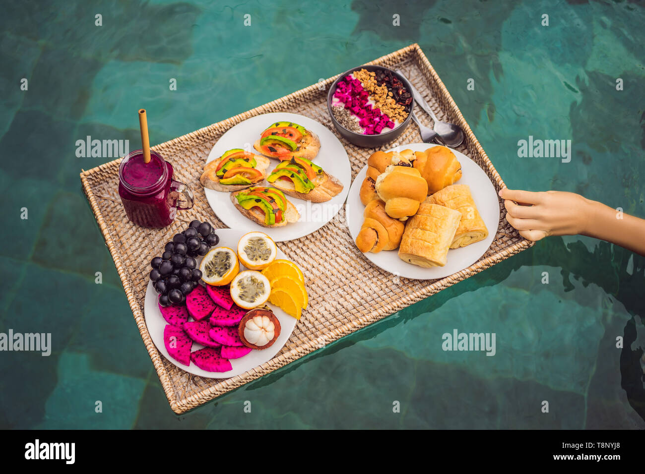 Breakfast tray in swimming pool, floating breakfast in luxury hotel