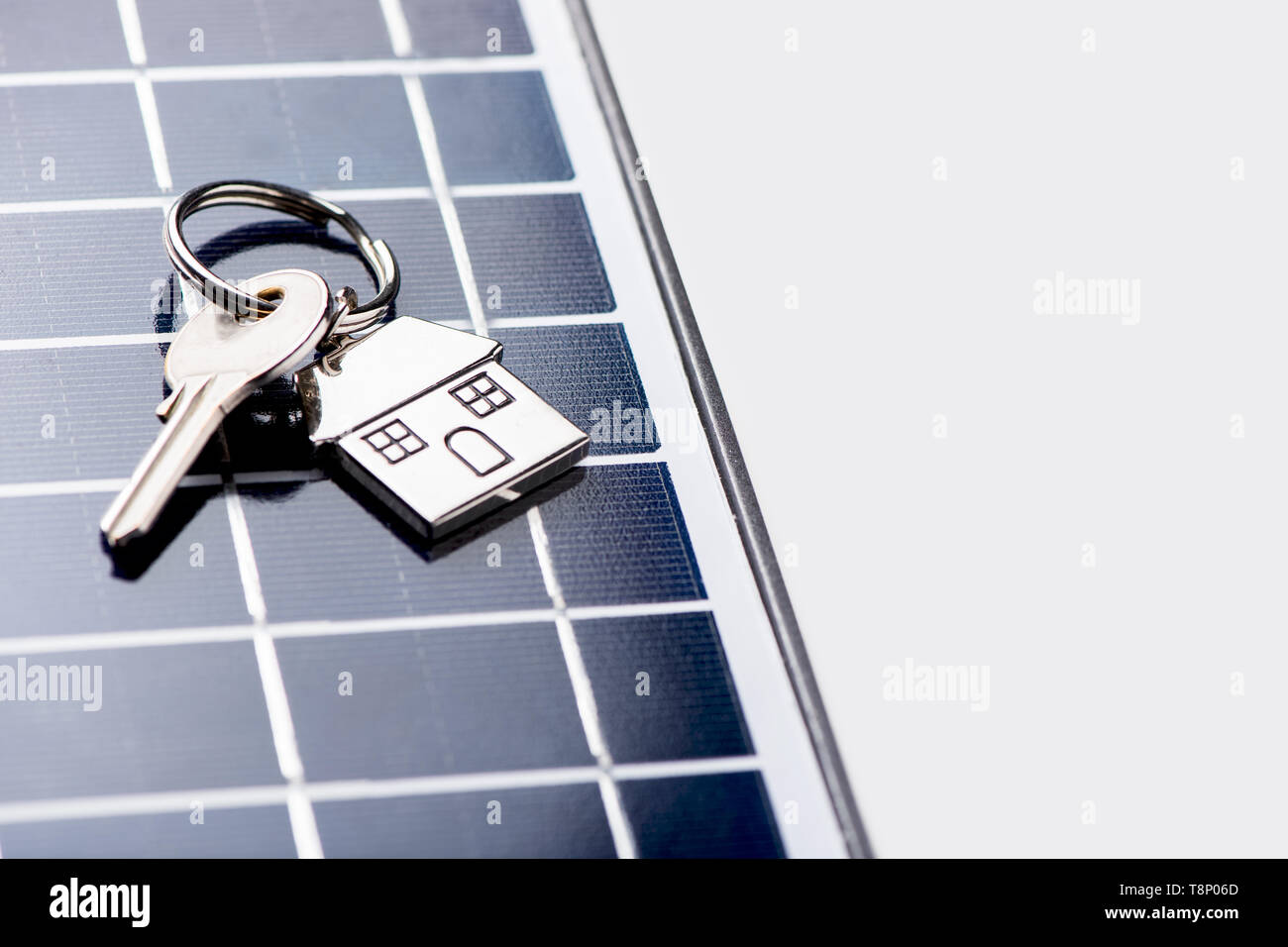 A solar panel with house key. Eco house new home concept Stock Photo