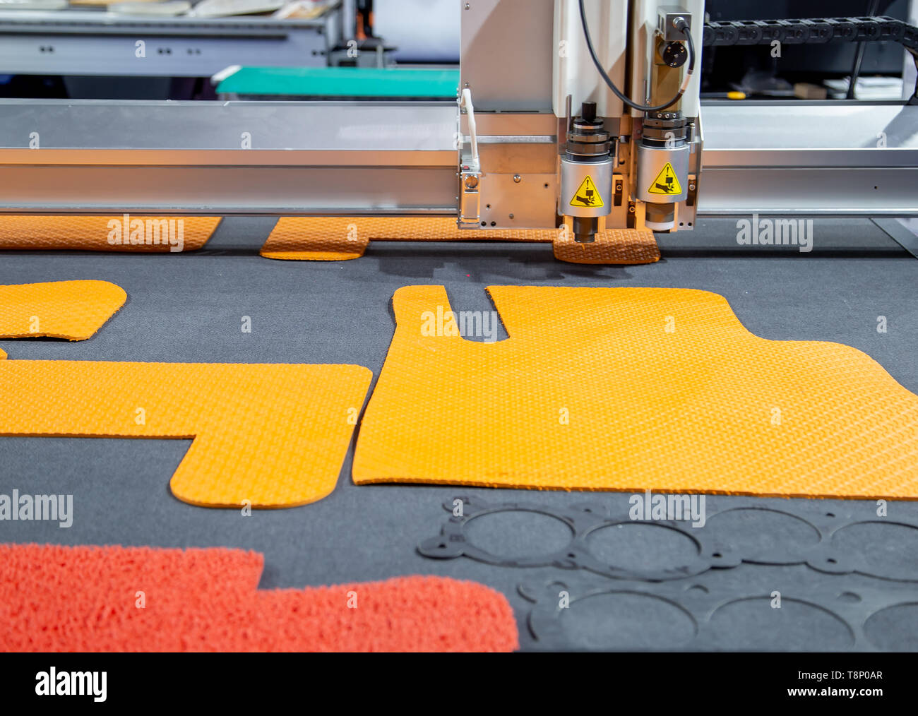 Laser cutting machine cutting car carpet mat and engine gasket Stock Photo Alamy