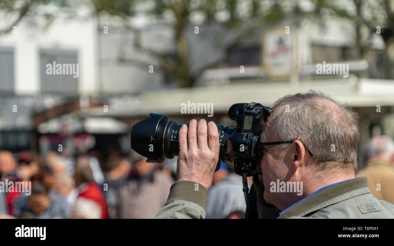 Wolfsburg, Germany, May 1, 2019: Reporter films with a professional black  video camera Stock Photo - Alamy