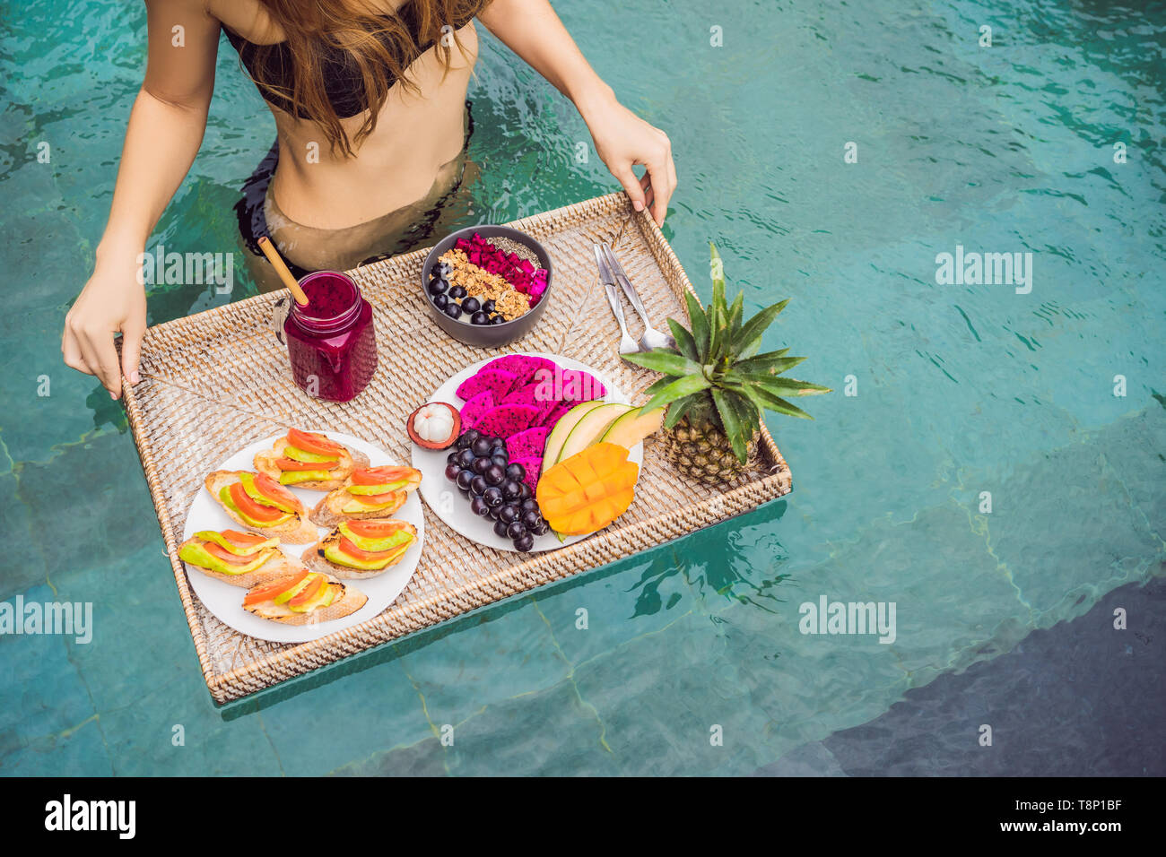 Breakfast tray in swimming pool, floating breakfast in luxury hotel