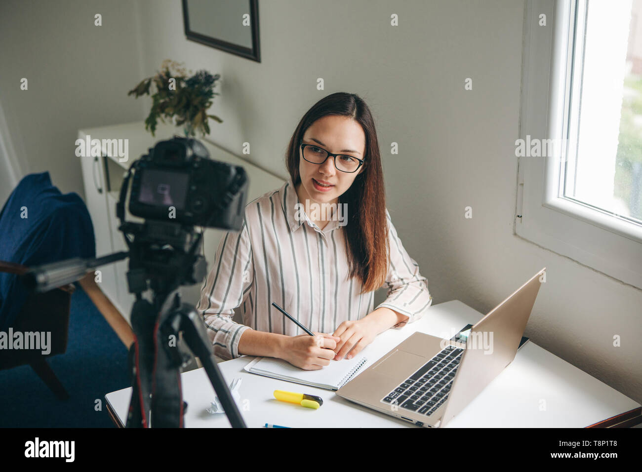 Girl blogger records video for their subscribers. Infobusiness or information business or hobby or online training or education for people. Stock Photo