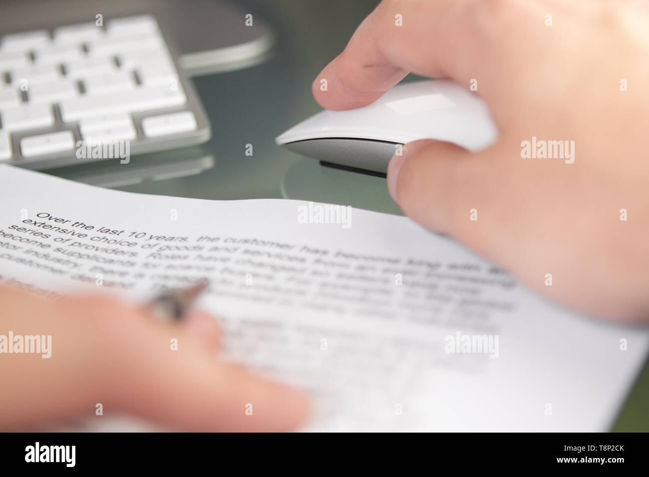 An office worker business person working at a desk using a mouse and ...