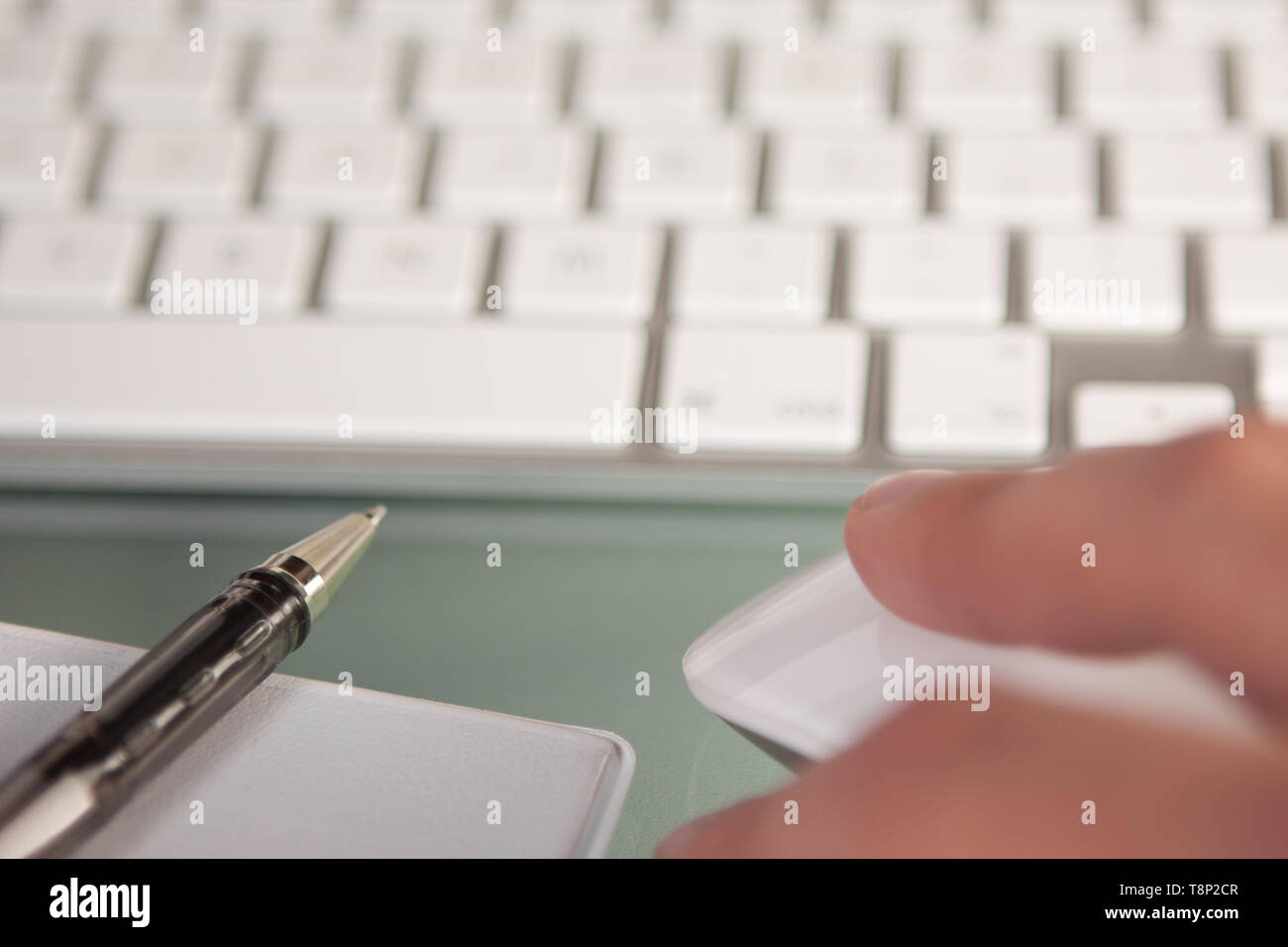 An office worker business person working at a desk using a mouse and ...