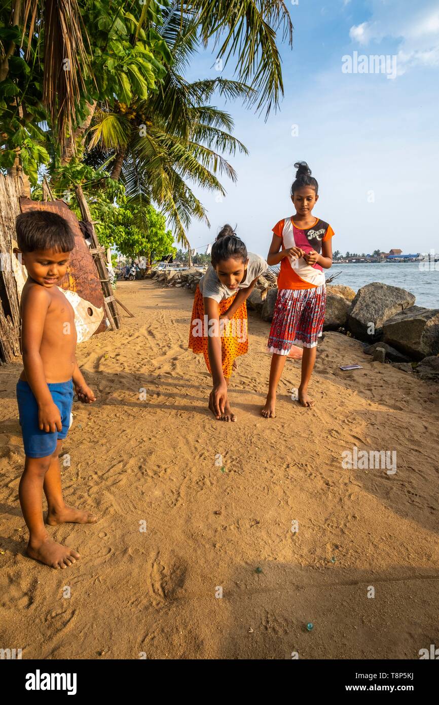 Sri Lanka, Western Province, Negombo, Children Playing Marbles Stock Photo - Alamy