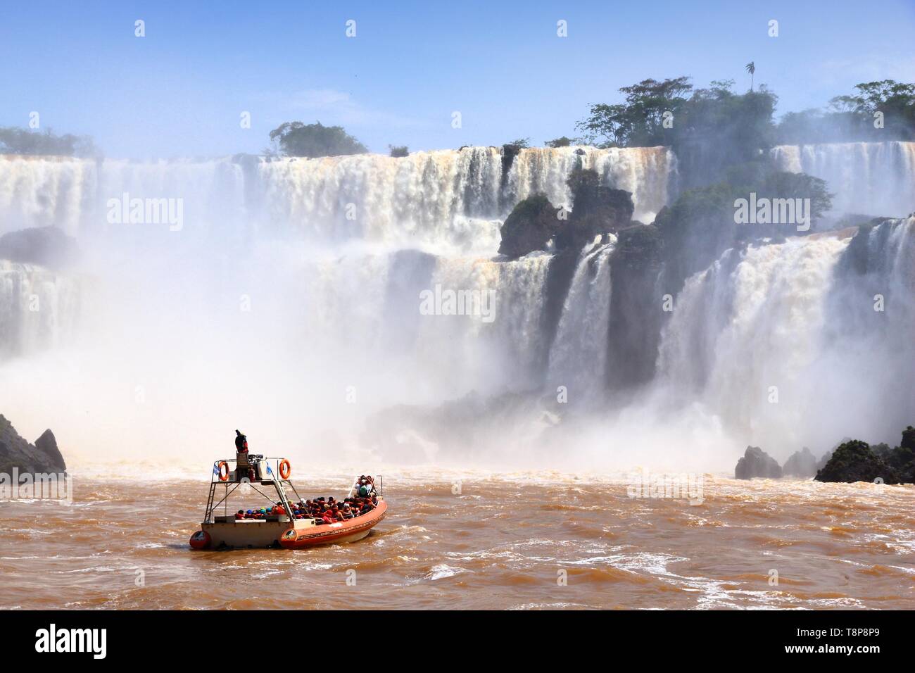 IGUAZU NATIONAL PARK, ARGENTINA - OCTOBER 10, 2014: People enjoy boat tour of Iguazu National Park in Argentina. The park was established in 1934 and  Stock Photo