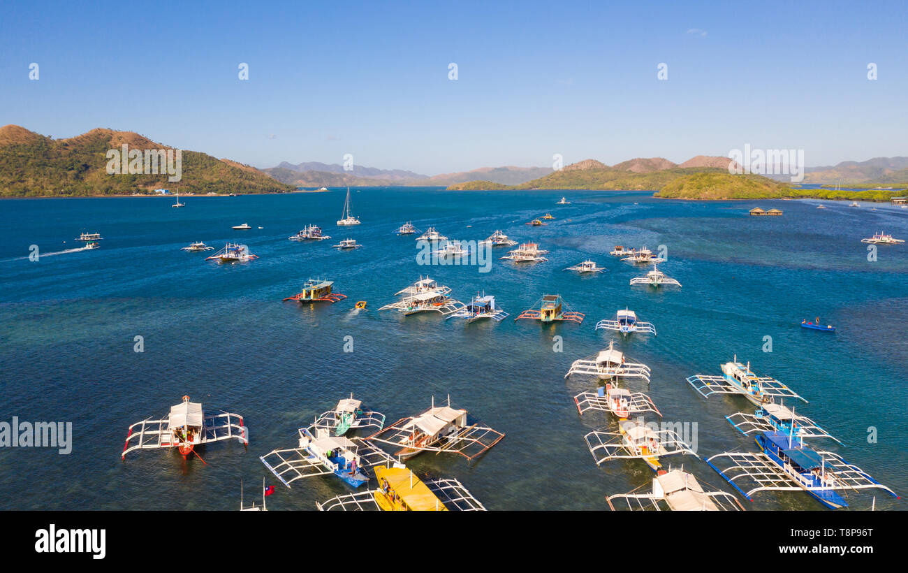 Many tourist boats float on the sea. Seascape with boats and islands