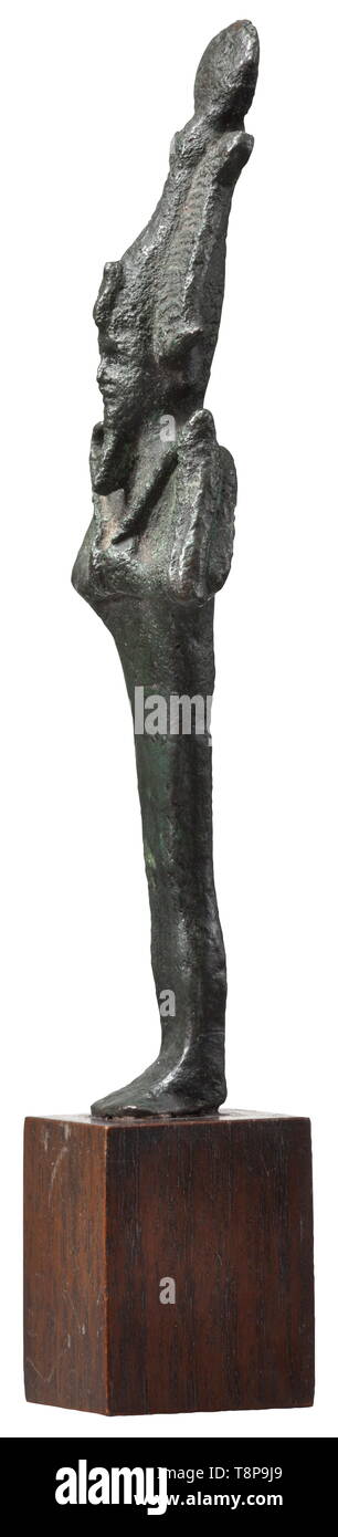 An ancient Egyptian bronze statuette of Osiris, Late Period, mid- to end of the 1st millennium BC The god depicted as upright standing mummy with Atef crown, holding crook and flail against his chest. On a modern wooden base. Length 16 cm. Provenance: 1970s private collection from the Munich area. historic, historical, ancient world, Additional-Rights-Clearance-Info-Not-Available Stock Photo