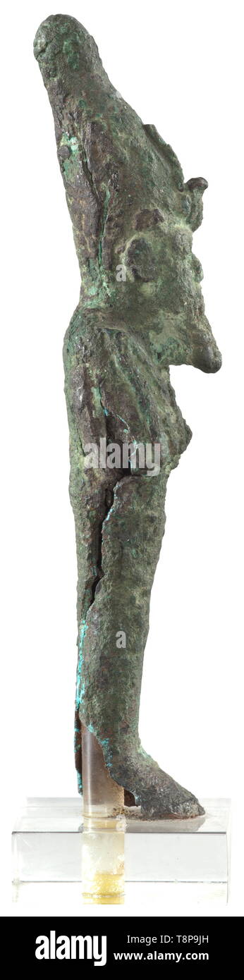 An ancient Egyptian bronze statuette of Osiris, Late Period, mid- to end of the 1st millennium BC Hollow, upright standing figure of the god as mummy with hedjet (white Crown of the South), holding crook and flail against his chest. The surface is corroded, the right side along the small slit is split open. On a plastic base. Length 13.2 cm. Provenance: 1970s private collection from the Munich area. historic, historical, ancient world, Additional-Rights-Clearance-Info-Not-Available Stock Photo