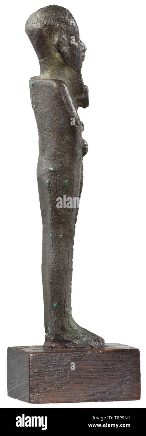 An ancient Egyptian bronze statuette of Ptah, Late Period, mid to end of the 1st millennium BC Upright standing depiction of the god as mummy with beard and cap, holding the Ankh-Djed-Was-sceptre in his hands. On a modern wooden base. Length without base 9.7 cm. Provenance: 1970s private collection from the Munich area. historic, historical, ancient world, Additional-Rights-Clearance-Info-Not-Available Stock Photo