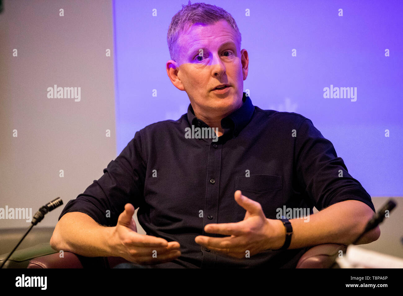 Comedian Patrick Kielty in conversation with host Mark Carruthers during a conference at the University of Ulster's Belfast Campus on ending sectarianism. Stock Photo