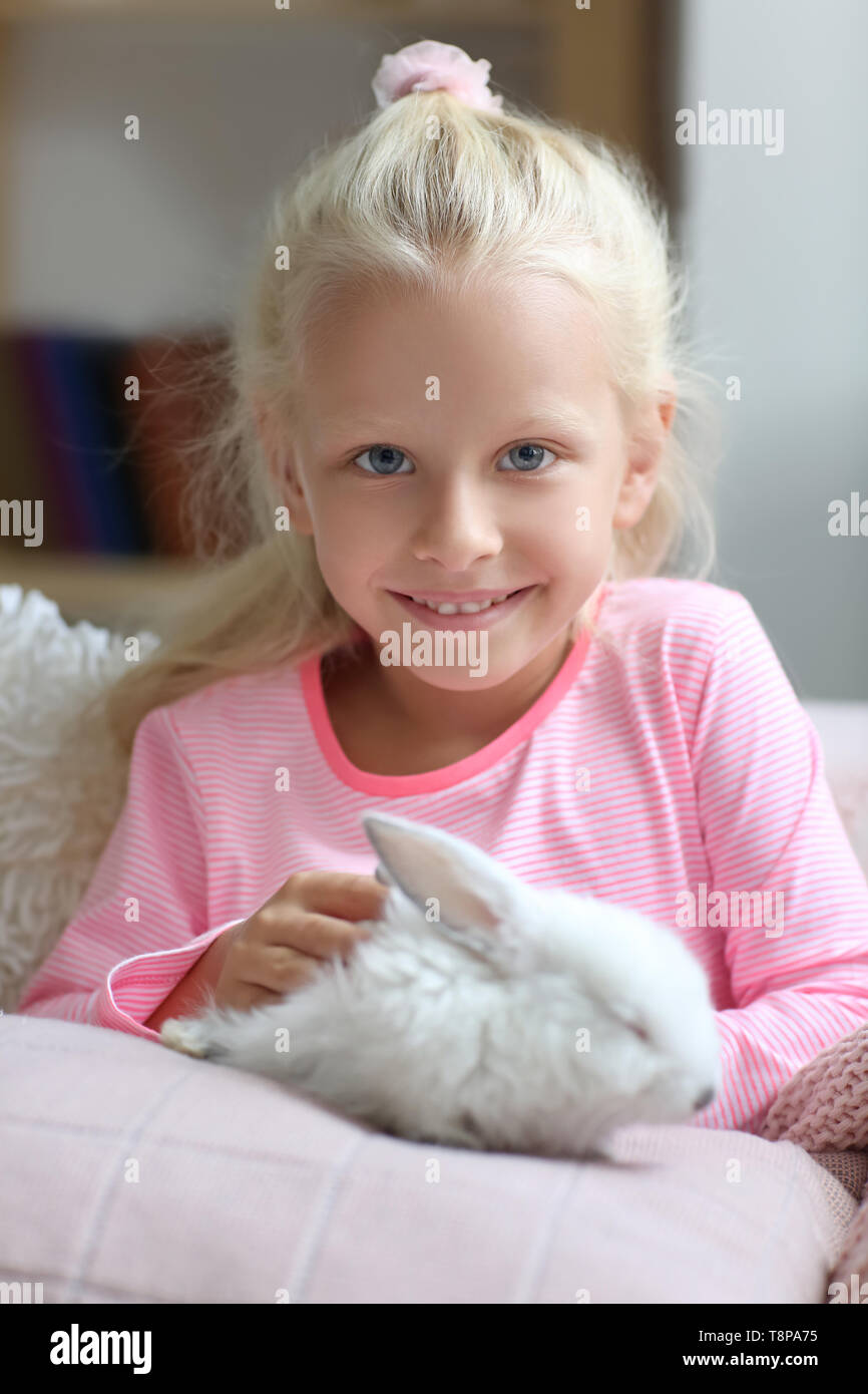 Little girl with cute rabbit at home Stock Photo - Alamy