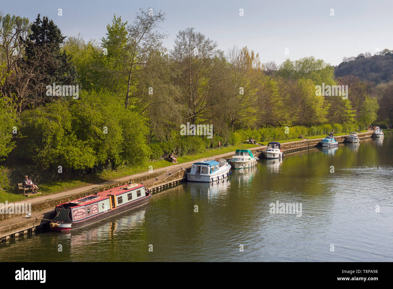 A narrow boat and cabin cruisers moored on the River Thames at Goring-on-Thames Stock Photo