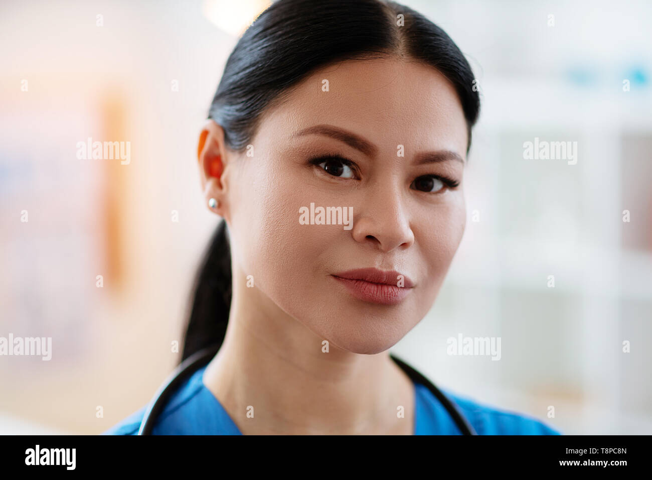 Dark-haired woman with tied hair being a doctor Stock Photo