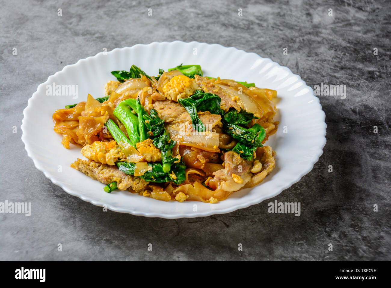 Stirfried Fresh Riceflour Noodles With Sliced Pork, Egg and Kale. Quick noodle stirfry Stock