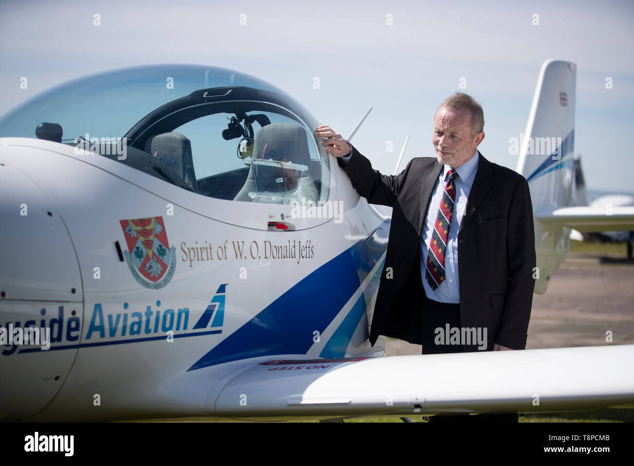 Philip Jeffs stands alongside the plane named after his late father Donald Jeffs which is one of a quartet of aircraft commemorating one of the most poignant tales of wartime Britain at Tayside Aviation, Dundee. Stock Photo