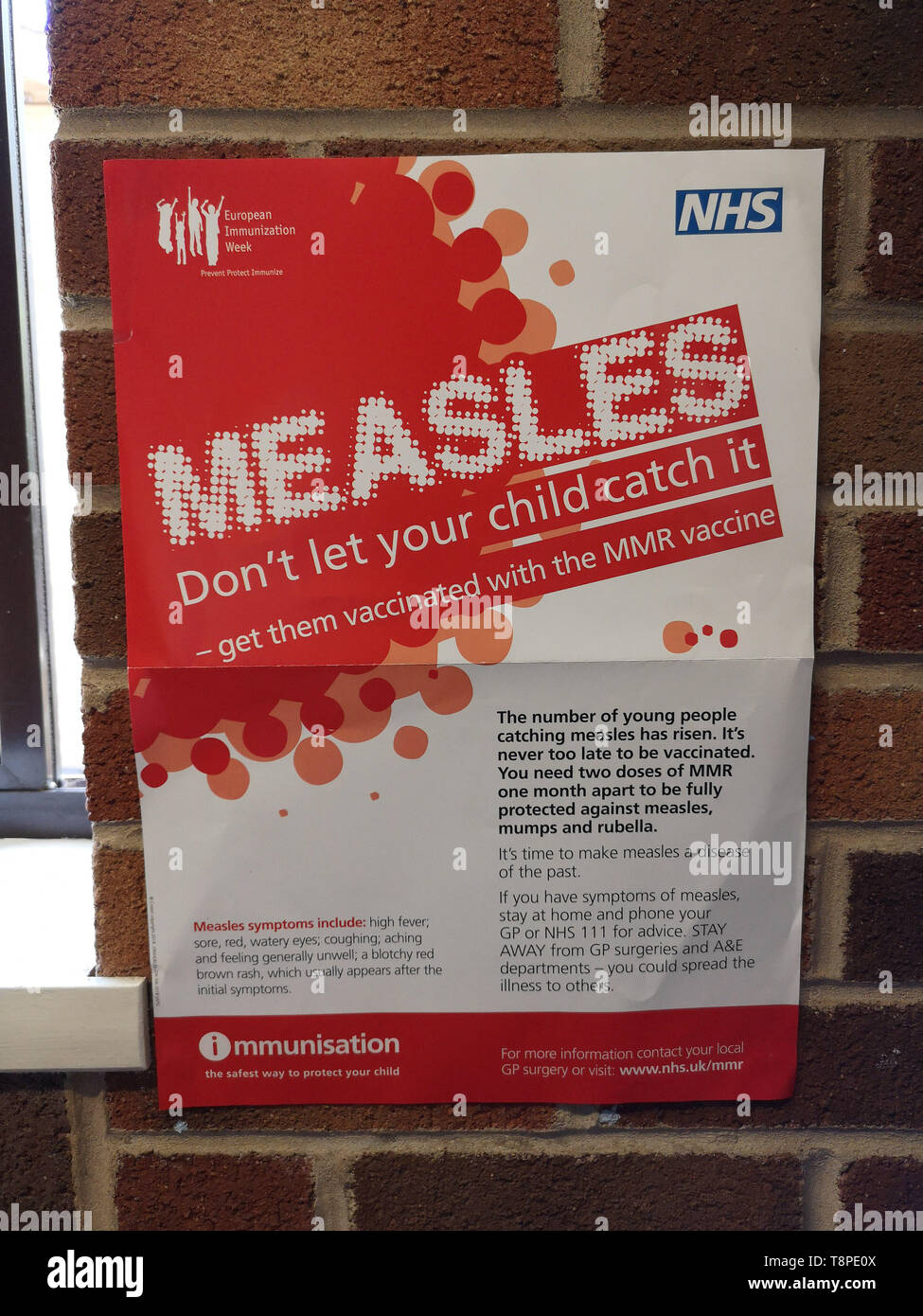 A poster with advice for patients about measles is seen in an NHS local doctors surgery waiting room in Warwickshire, UK, On May 14, 2019. Stock Photo