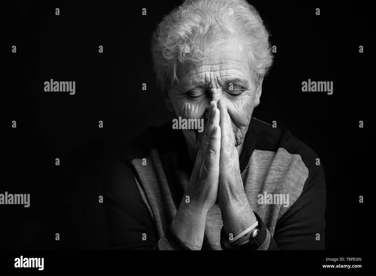 Depressed elderly woman on dark background Stock Photo - Alamy