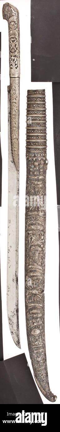 A silver-mounted Cretan yataghan, 1st half of the 19th century Slightly curved (partially slightly corroded) blade, with fullers and geometrical cuttings on the back as well as a blacksmith's mark on the reverse side. Florally chased blade clamp with chased silver grip. Two-piece all-silver scabbard with chasings of ships, trophies of war and blossom tendrils in relief. The chape with a three-dimensional monster's head, the scabbard with tughra stamp. Beautiful workmanship, the silver tarnished in some parts. Length 82 cm. historic, historical, O, Additional-Rights-Clearance-Info-Not-Available Stock Photo