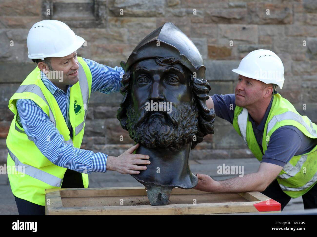 Drew Leslie (left) from Stirling Council alongside Dan Lea from Lost Art Project with part of the bronze statue of William Wallace which is being returned to the National Monument in Stirling after undergoing vital restoration work. Stock Photo