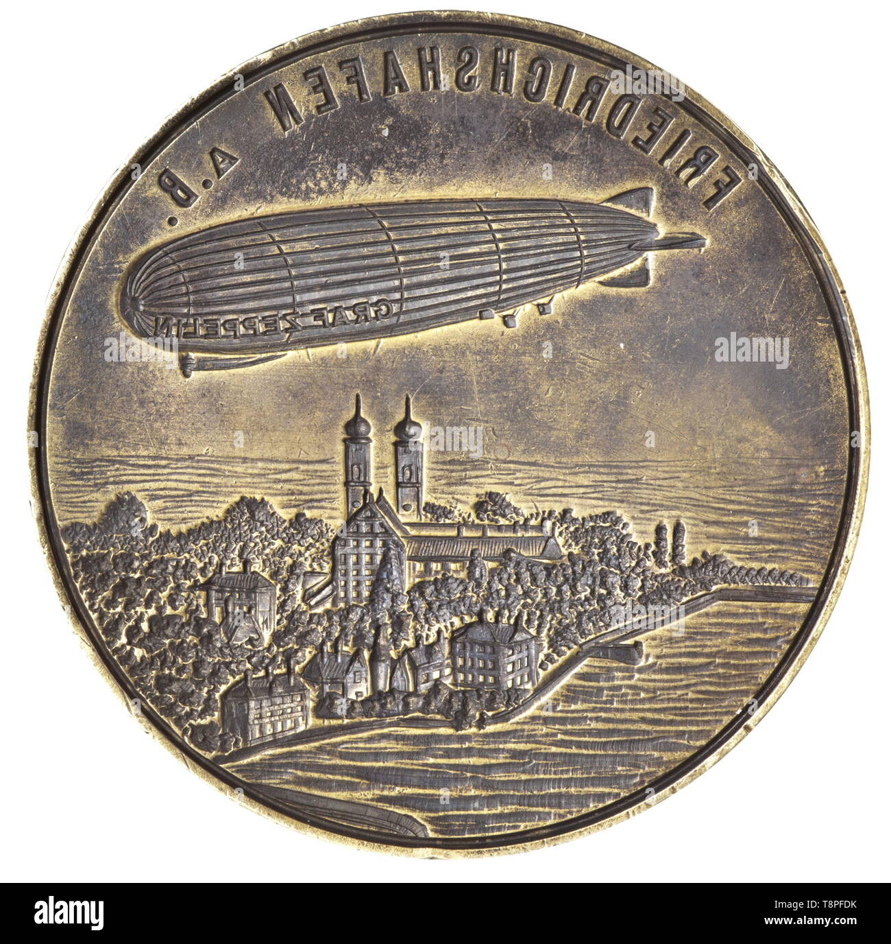 A ship's seal of the 'Graf Zeppelin' airship A large brass seal with the air ship LZ 127 'Graf Zeppelin' above the city of Friedrichshafen on the Bodensee cut into the surface of the seal. The inscription, 'BORDSIEGEL D-LZ 127 'GRAF ZEPPELIN' WELT-FAHRT 1929' ('SHIP'S SEAL D-LZ 127 'GRAF ZEPPELIN' ROUND THE WORLD VOYAGE 1929') is engraved on the stepped rim. Finely turned hardwood grip. Height 11.5 cm. The 'Graf Zeppelin' was 236.6 m long with a diameter of 30.5 m and a buoyant gas volume of 105,000 cubic meters. It was built in Friedrichshafen b, Additional-Rights-Clearance-Info-Not-Available Stock Photo