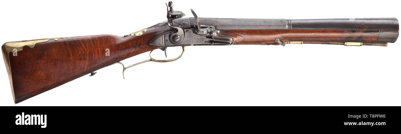 A flintlock blunderbuss, Nicolaus Koch, Vienna, circa 1730 Strong two-stage barrel, octagonal then round after a girdle, with oval muzzle. At the breech a brass-filled mark 'KOCH', the tang numbered '1'. Smooth flintlock with foldout frizzen on the side, signed on the lock plate 'NICOLAUS KOCH IN WIENN'. Beautiful walnut full stock with horn nose and smooth brass furniture, the wooden ramrod with horn tip. The brass escutcheon with finely engraved coat of arms, surrounded by the continuous device 'CONSTANT FI DE SIN CERITATE'. Blunderbuss of unus, Additional-Rights-Clearance-Info-Not-Available Stock Photo