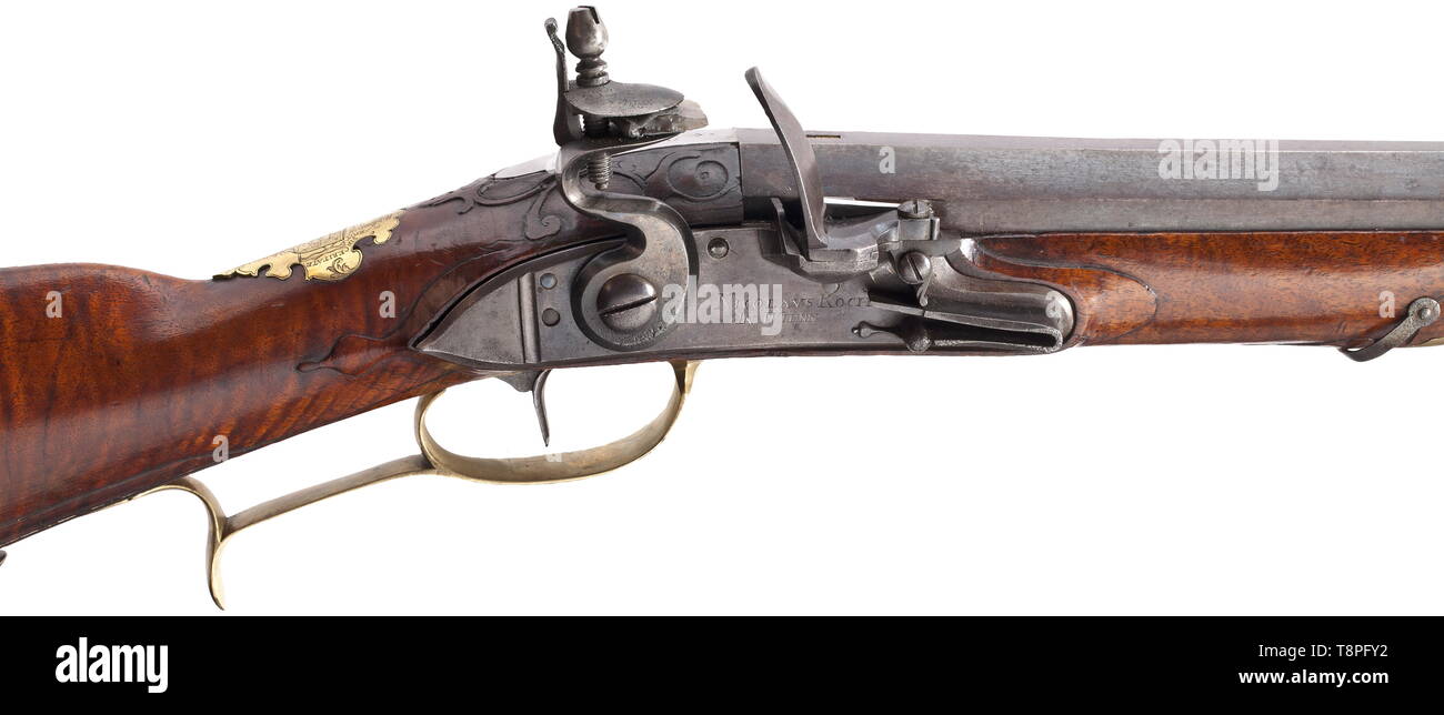 A flintlock blunderbuss, Nicolaus Koch, Vienna, circa 1730 Strong two-stage barrel, octagonal then round after a girdle, with oval muzzle. At the breech a brass-filled mark 'KOCH', the tang numbered '1'. Smooth flintlock with foldout frizzen on the side, signed on the lock plate 'NICOLAUS KOCH IN WIENN'. Beautiful walnut full stock with horn nose and smooth brass furniture, the wooden ramrod with horn tip. The brass escutcheon with finely engraved coat of arms, surrounded by the continuous device 'CONSTANT FI DE SIN CERITATE'. Blunderbuss of unus, Additional-Rights-Clearance-Info-Not-Available Stock Photo