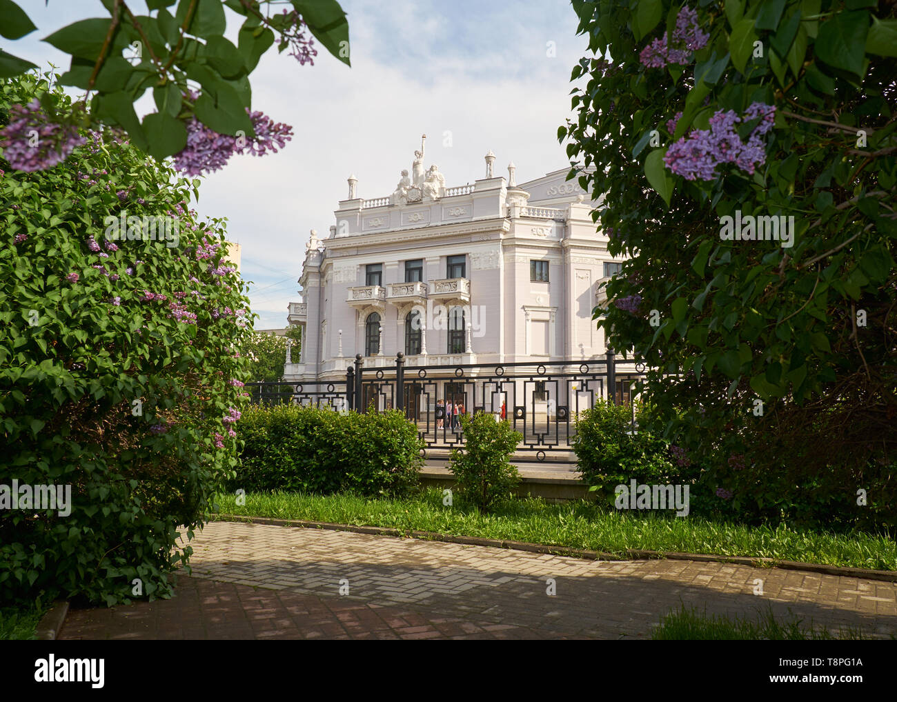 Opera and Ballet theater through the lilac bushes in the Spring, Ekaterinburg, Russia Stock Photo
