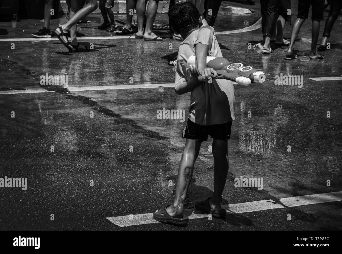A young boy shot with water in Songkran Stock Photo