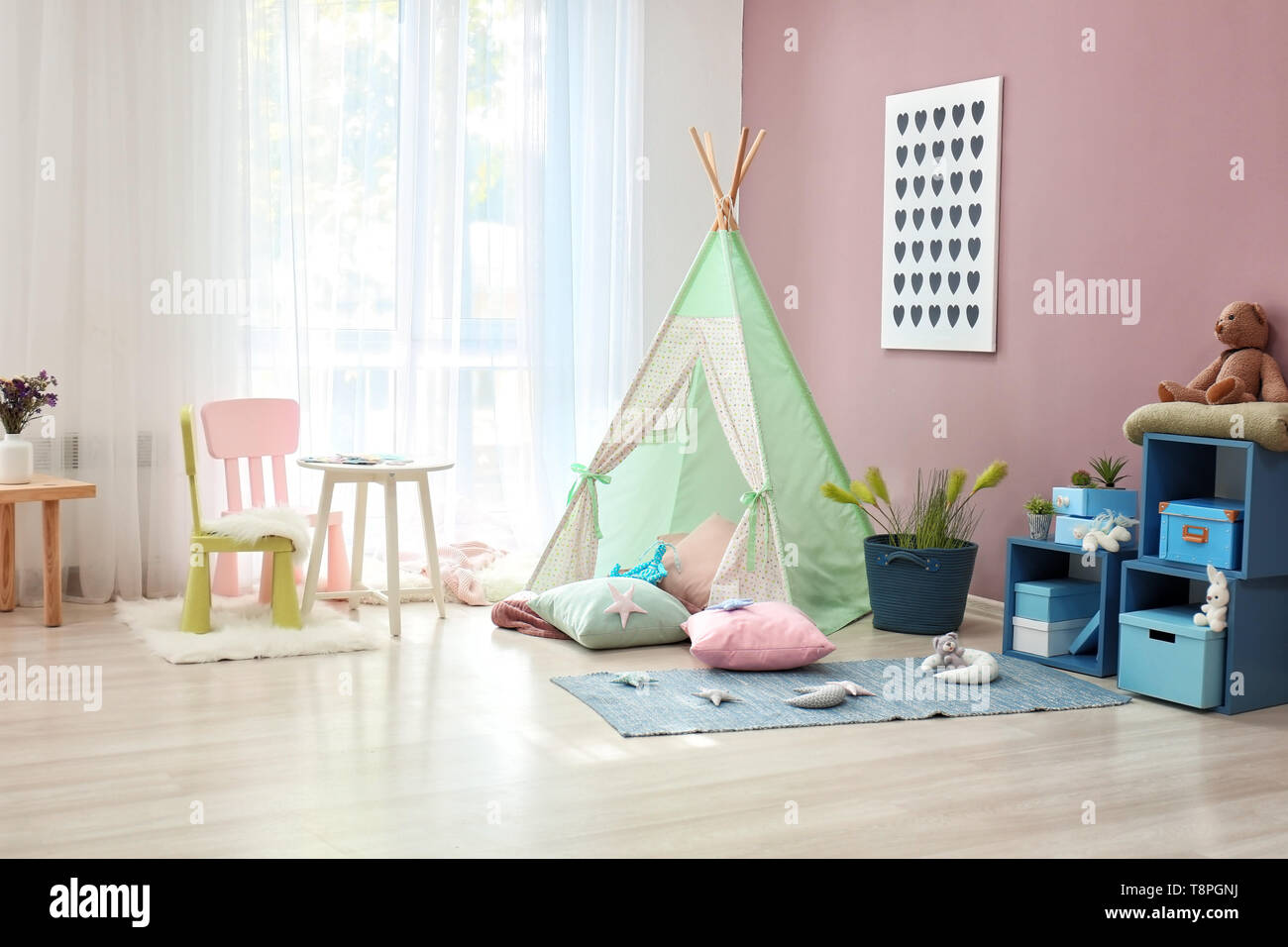 Cozy play tent for kids in interior of room Stock Photo