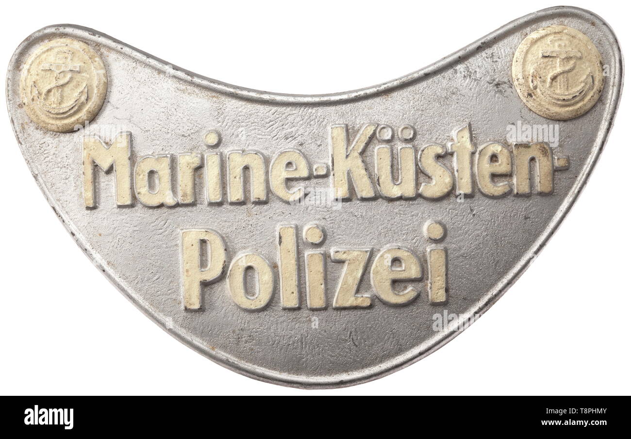 A gorget for the naval coastal police service badge from 1940/41 Lacquered silver-coloured iron shield with concurrently stamped legend, which together with the separately applied anchor buttons at the corners is highlighted in luminescent paint. Field-grey liner, iron lateral attachment pin system. The Marine-Küsten-Polizei (MKP) was established in 1940 as a policing and regulations enforcement service of the Kriegsmarine. The small units were answerable to the port commanders as a regulatory service for ships lying in harbour, and also policed river fisheries etc. The shi, Editorial-Use-Only Stock Photo