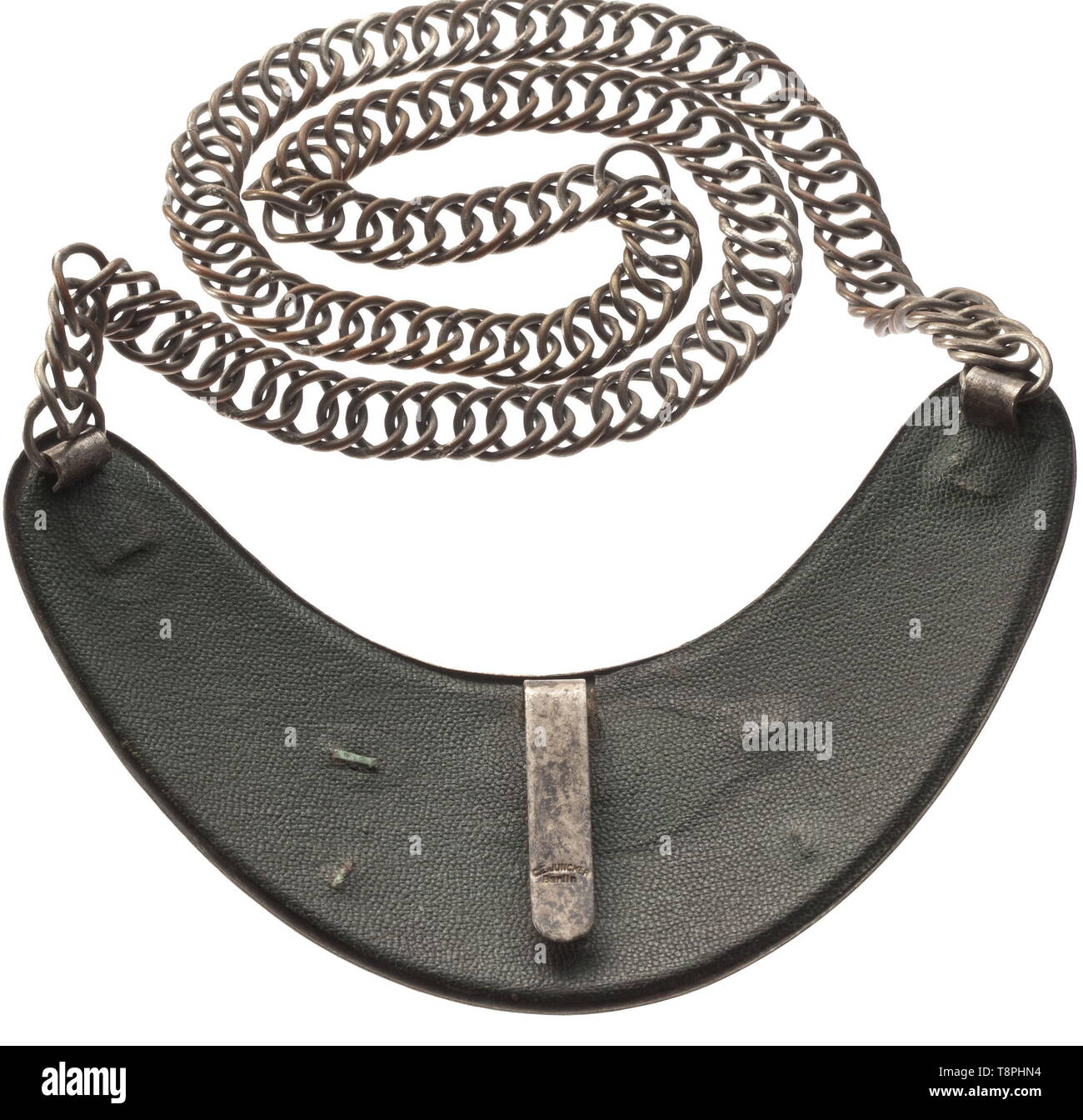 A gorget for members of the Reich Air Traffic Administration 1st model by C.E. Juncker, Berlin Kidney-shaped, silvered shield with gilt appliqué and lettering. Dark green leather liner, the arresting clasp with maker's stamping, nickel plated chain. Darkened. Raised in 1935 as a successor to the air policing service, the Reichs-Luft-Aufsicht (tr. Reich Air Traffic Administration) was officially answerable to the Luftfahrtministerium (tr. Air Ministry) and assumed the regulation and control of airports. historic, historical, 20th century, Additional-Rights-Clearance-Info-Not-Available Stock Photo