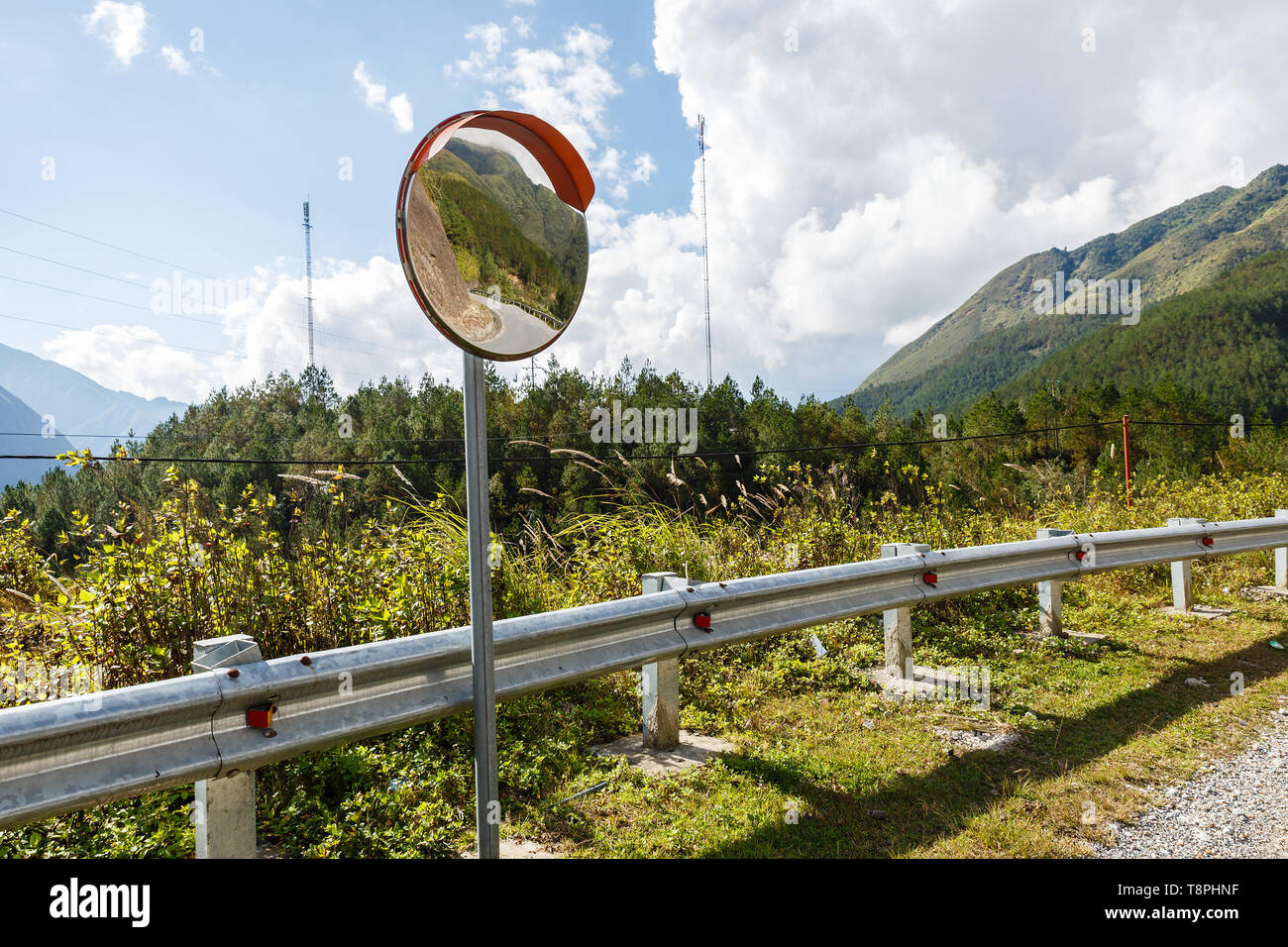 The traffic curve mirror, convex mirror on the road for safety Stock Photo