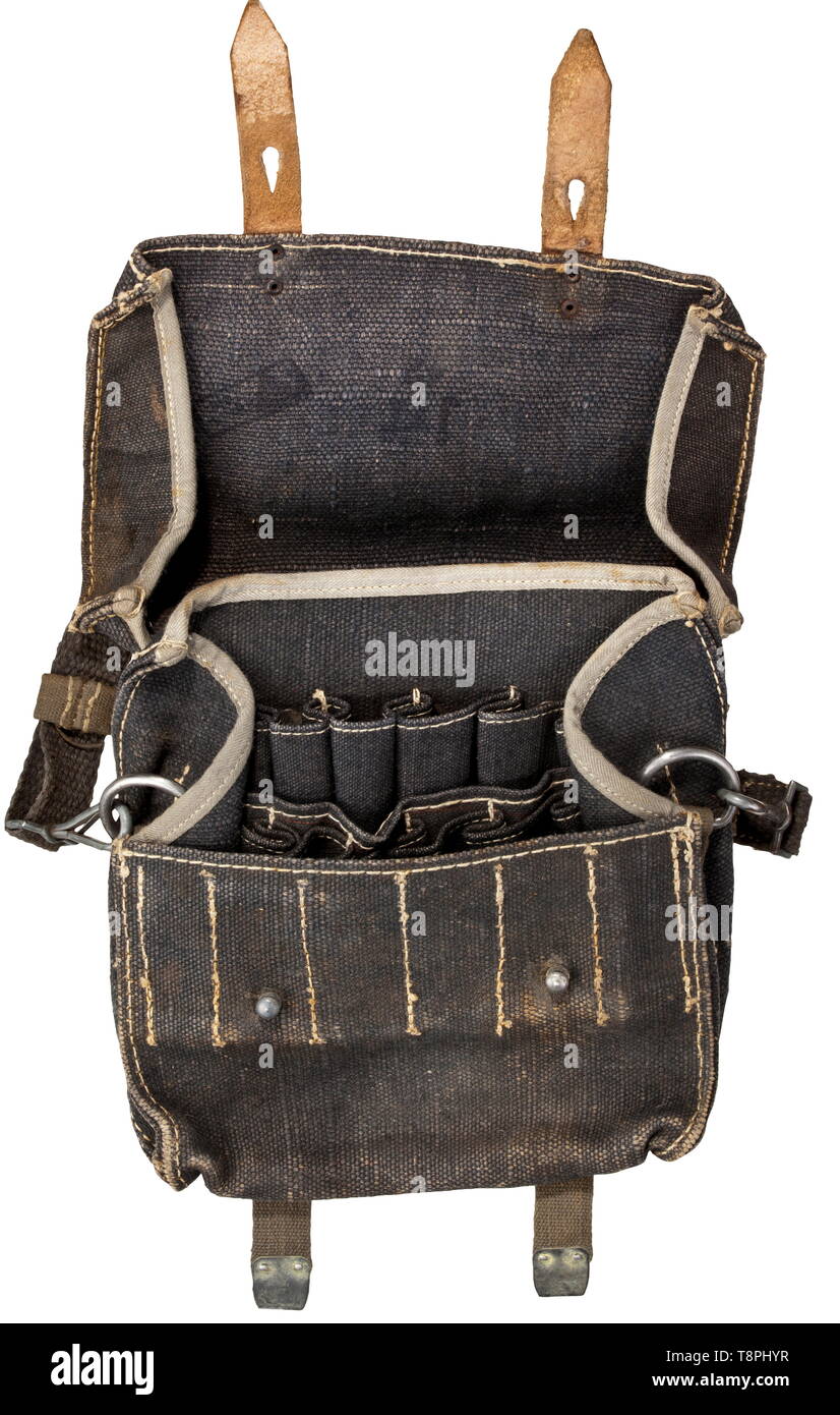 An ammunition pouch for 18 flare pistol cartridges in the cover an illegible ink stamping, circa 1942/43 Made from coarse grey-blue linen web material with leather trim, a wooden insert in the base. Web belting for optional carrying over the shoulder or on the belt, shoulder straps with two snap hooks. In never used, mint condition. historic, historical, Air Force, branch of service, branches of service, armed service, armed services, military, militaria, air forces, object, objects, stills, clipping, clippings, cut out, cut-out, cut-outs, 20th century, Editorial-Use-Only Stock Photo