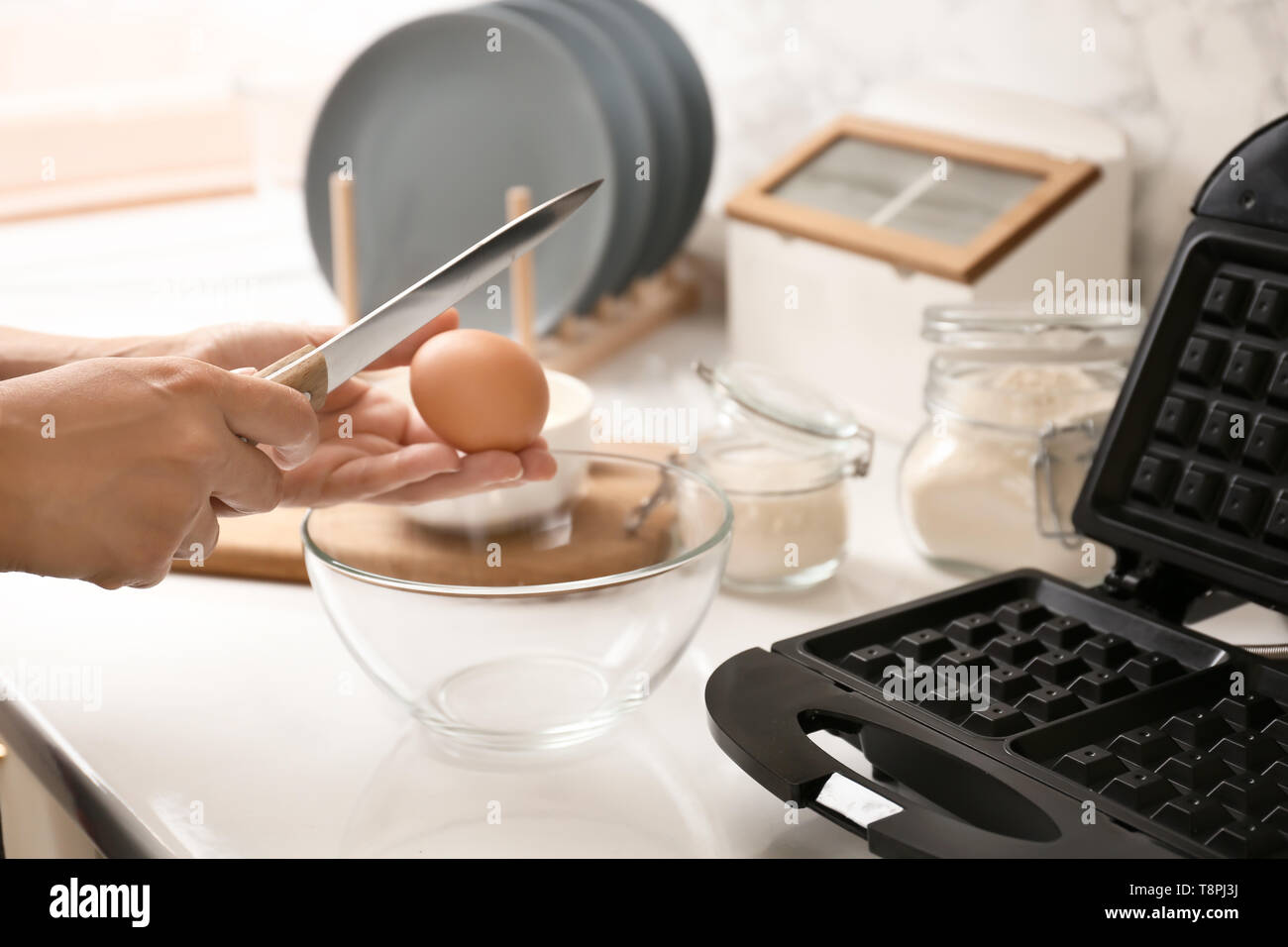 Woman making dough for waffles in kitchen Stock Photo