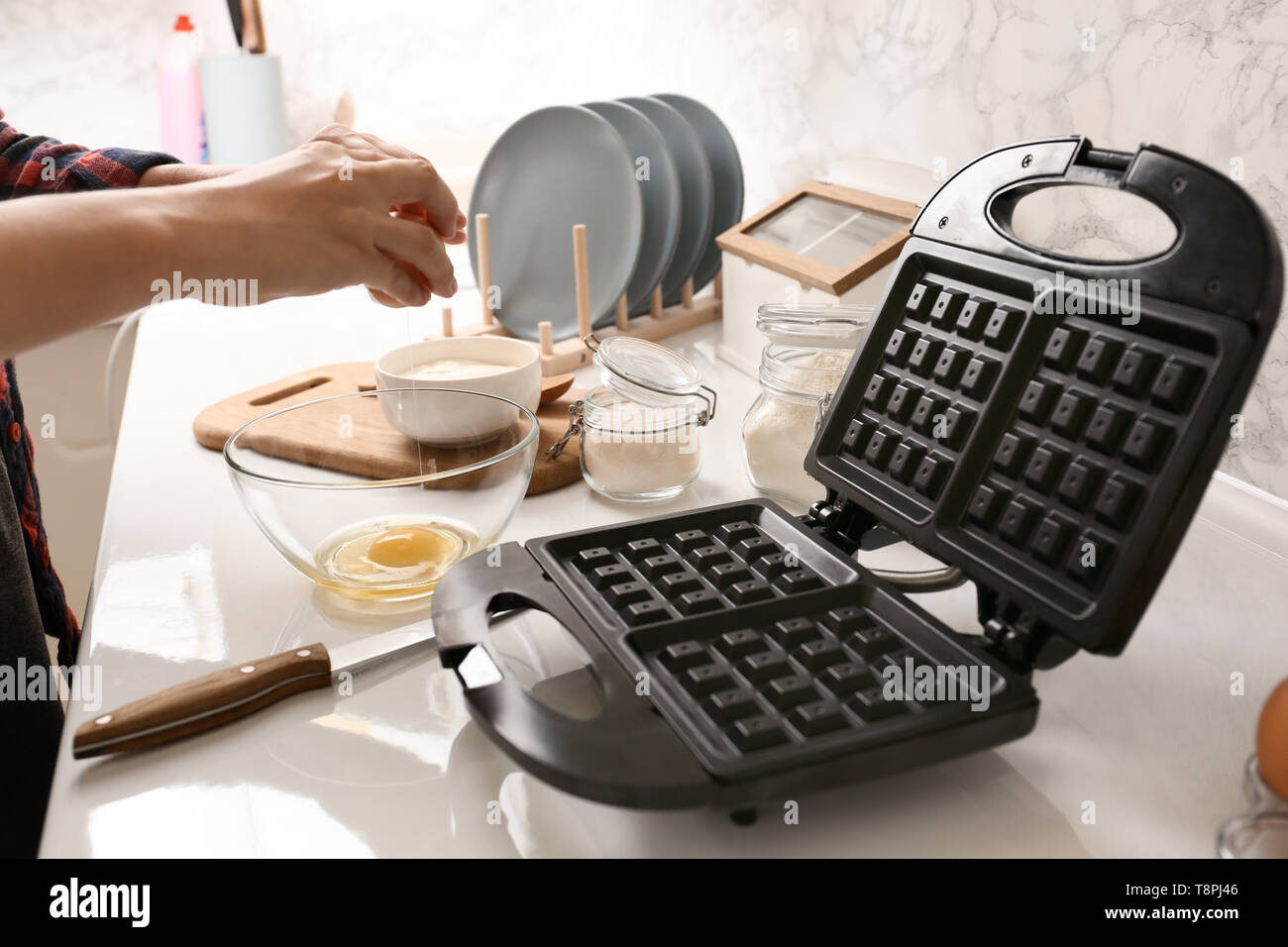 Woman making dough for waffles in kitchen Stock Photo