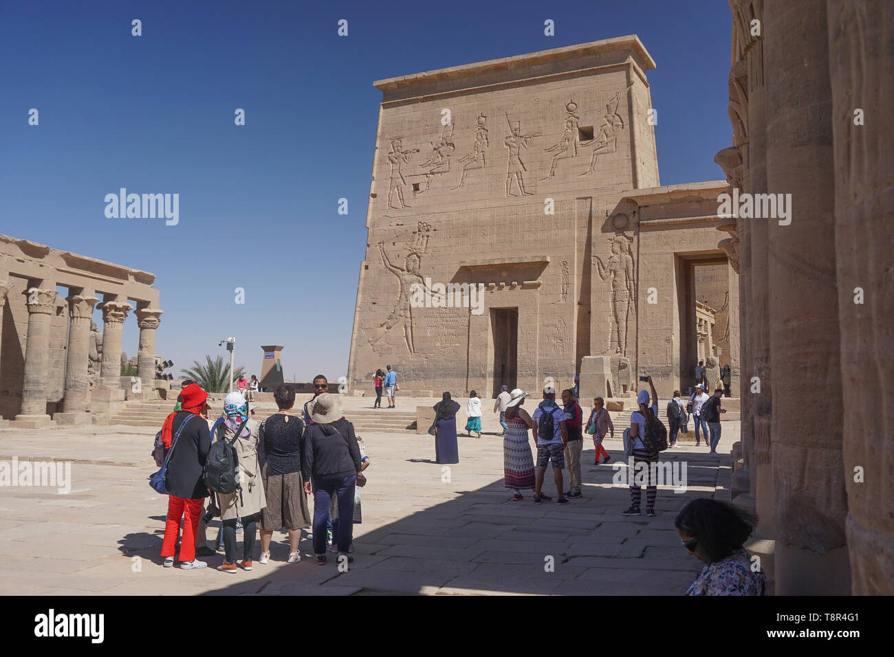 Aswan, Egypt: Tourists and guides at the temple complex of Philae, built during the Ptolemaic Kingdom, relocated to Agilkia Island in the 1960s. Stock Photo