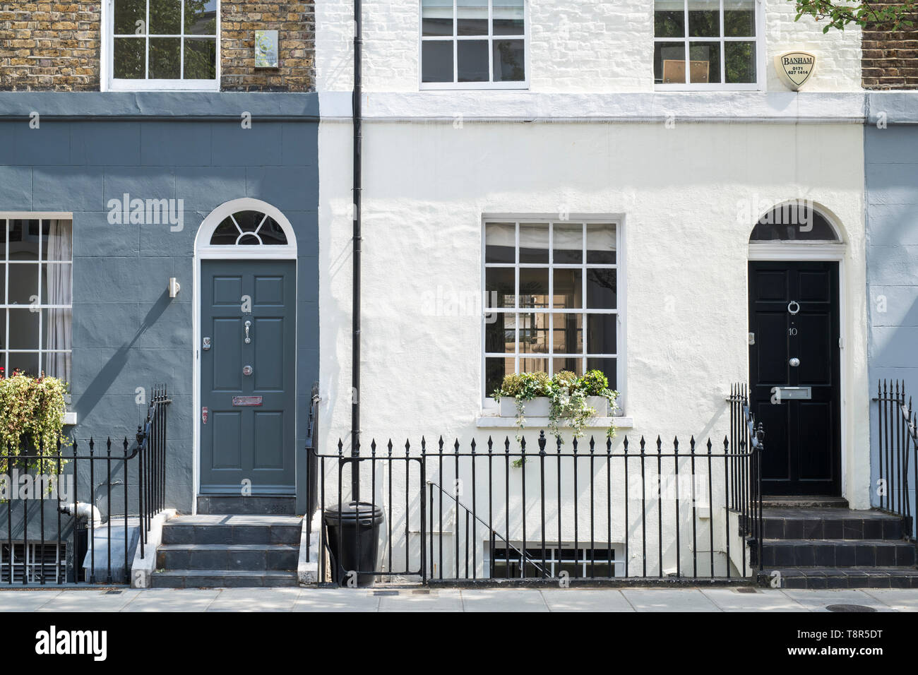 A Row of Brick Buildings with Black Doors on a Street in London Stock Image  - Image of architecture, english: 189002149