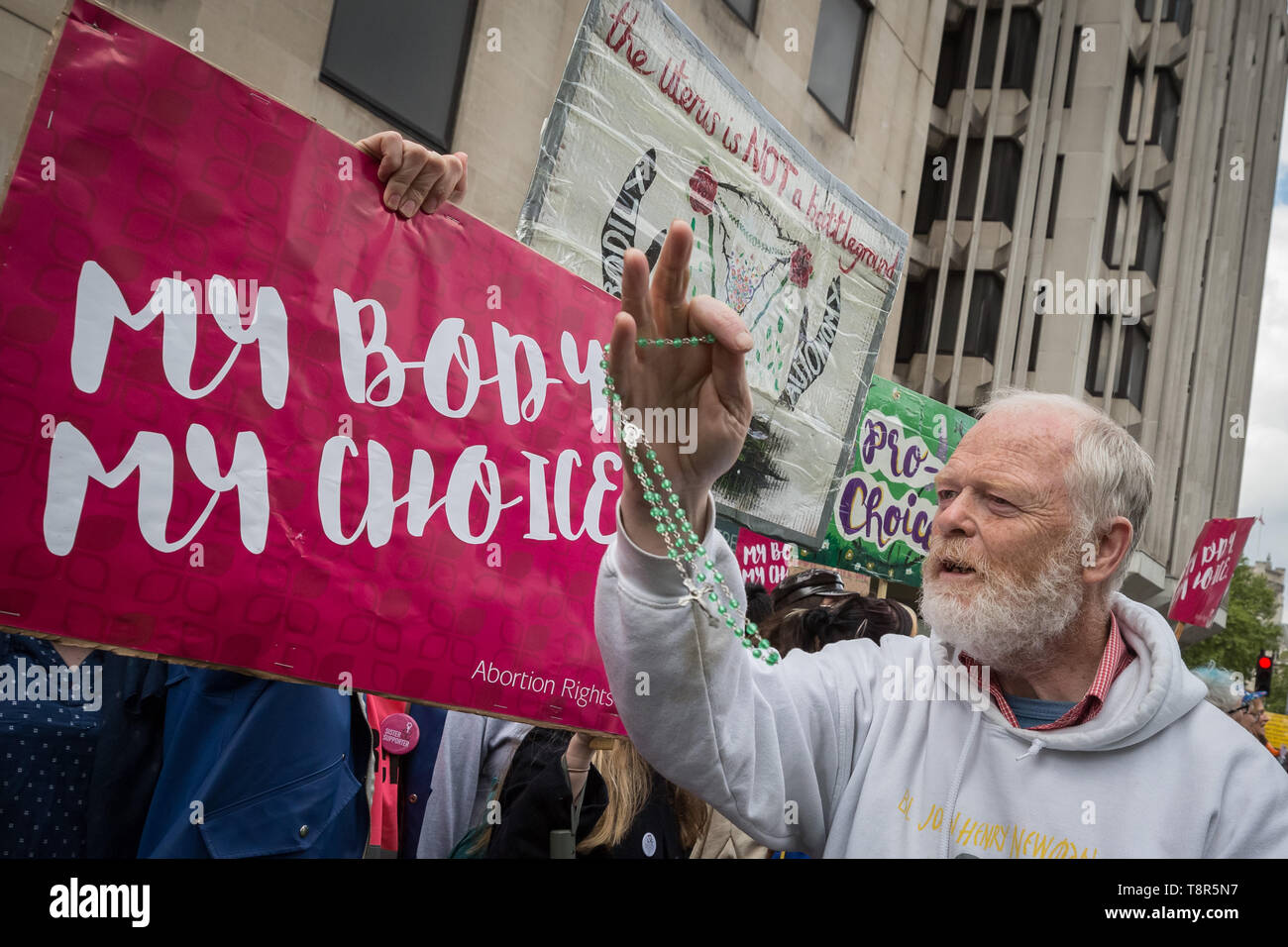 An anti-abortion Christian waves his holy rosaries at women’s rights pro-choice supporters as the groups clash during March for Life UK protest. Stock Photo