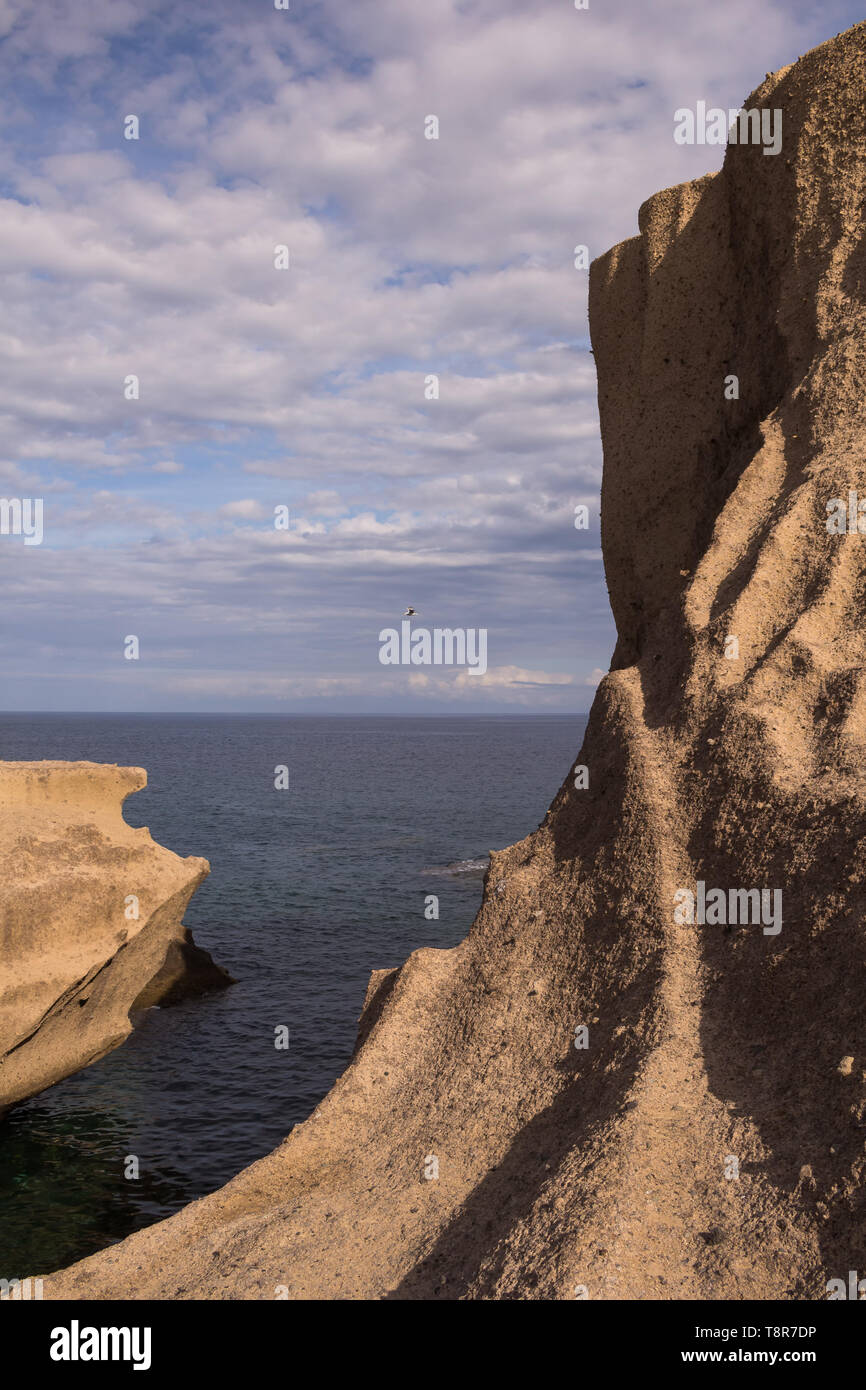 Sandstone, creating original rocks of tender shape. Calm Atlantic ocean ...