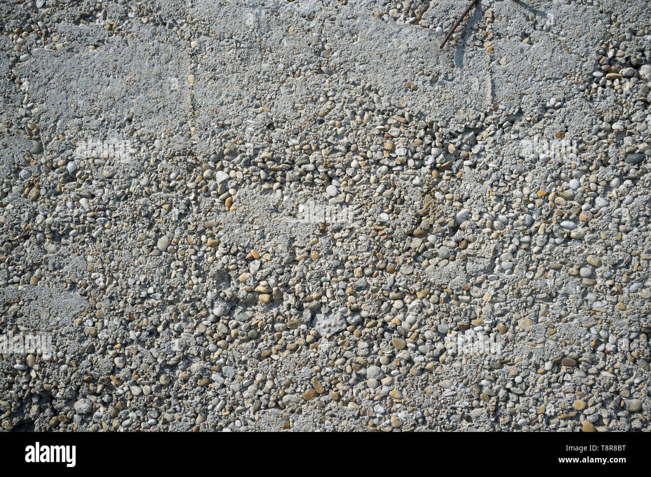 Crumbly Roughly Done Weathered Grey Concrete Wall with Pebbles Texture Detail Stock Photo