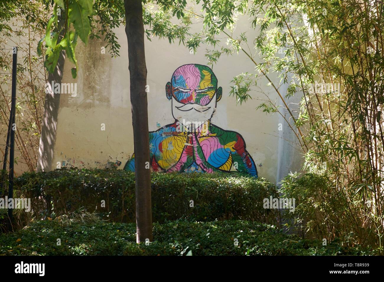 France, Paris, mural painting representing of a monk meditating in a small garden at the corner of rue d'Aboukir and rue des Petits Carreaux Stock Photo