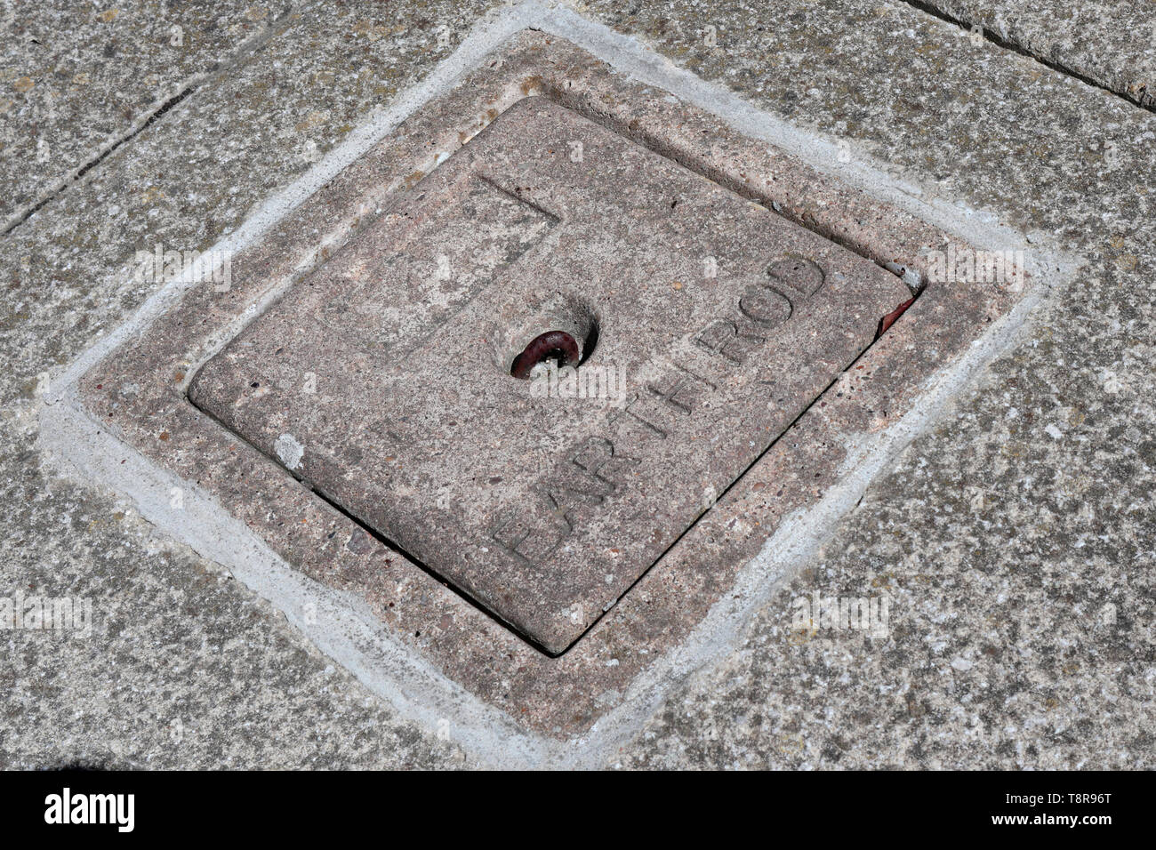 A concrete earthing rod pit cover. Stock Photo
