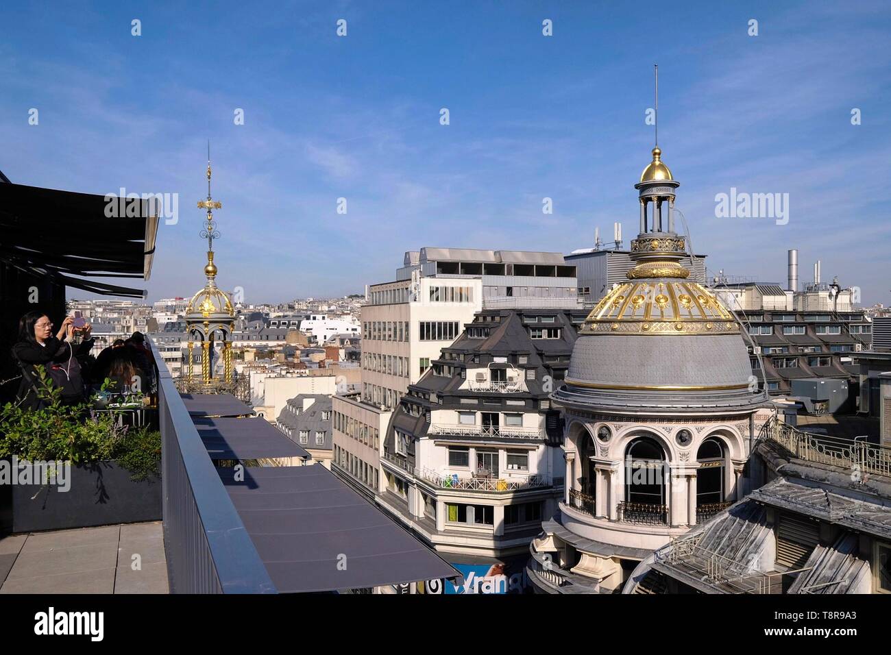 France, Paris, Boulevard Haussman, Restaurant terrace and the gilded dome of the department store Le Printemps Haussmann Stock Photo