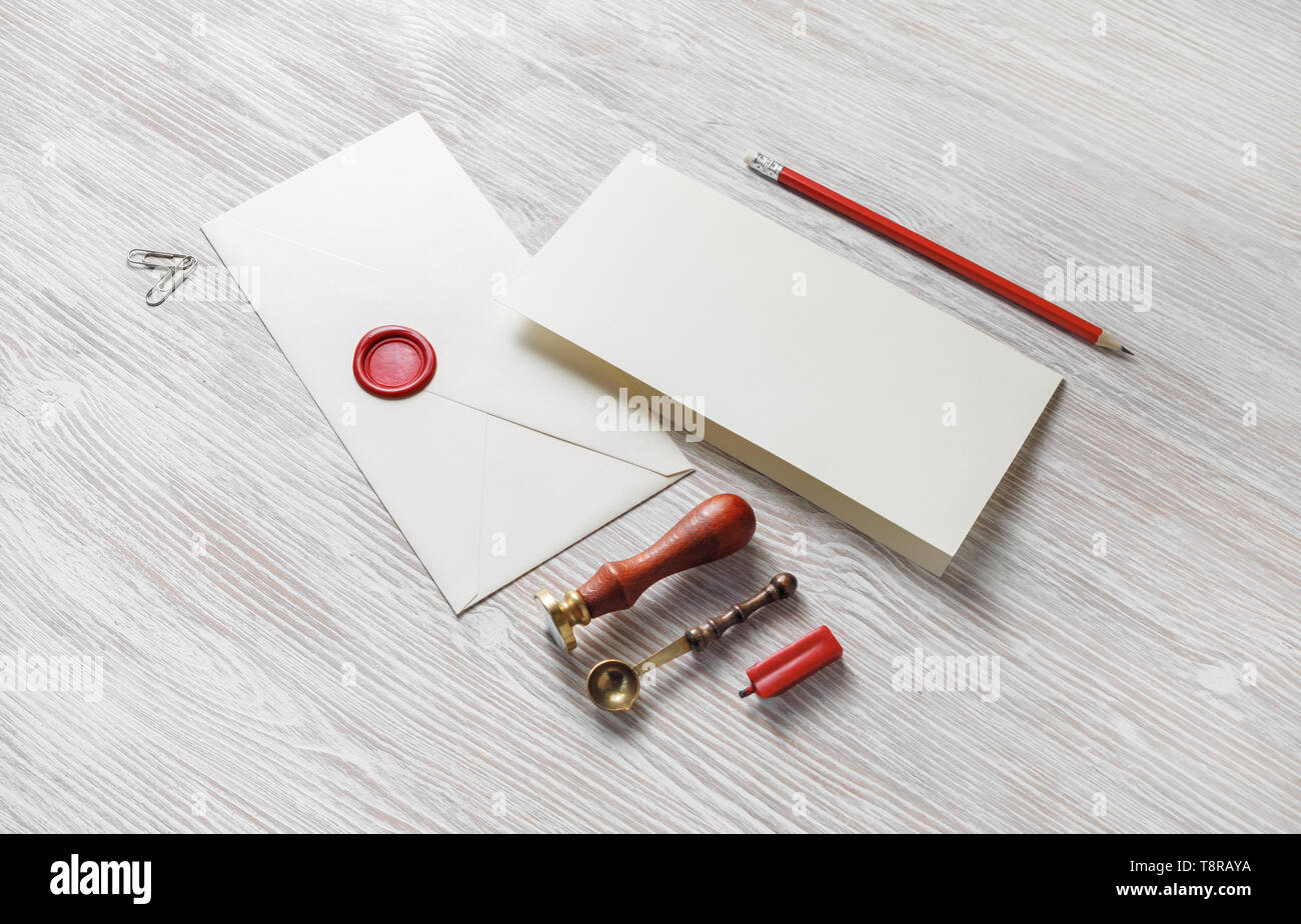 Vintage envelope and stationery on light wooden background. Responsive design mockup. Stock Photo