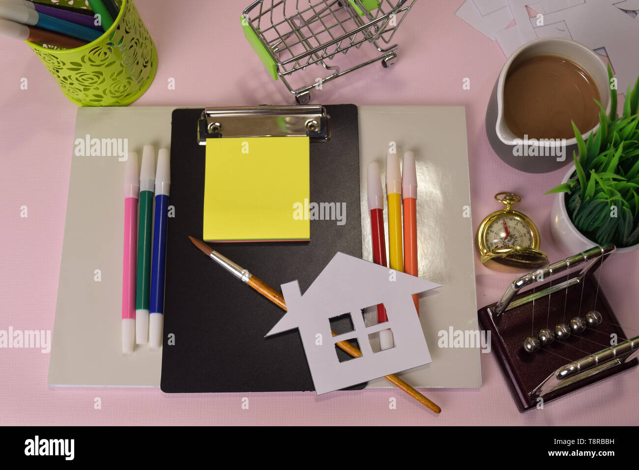 Homework Paper Top View Top view of the cutting paper or drawing house on a pink table ...