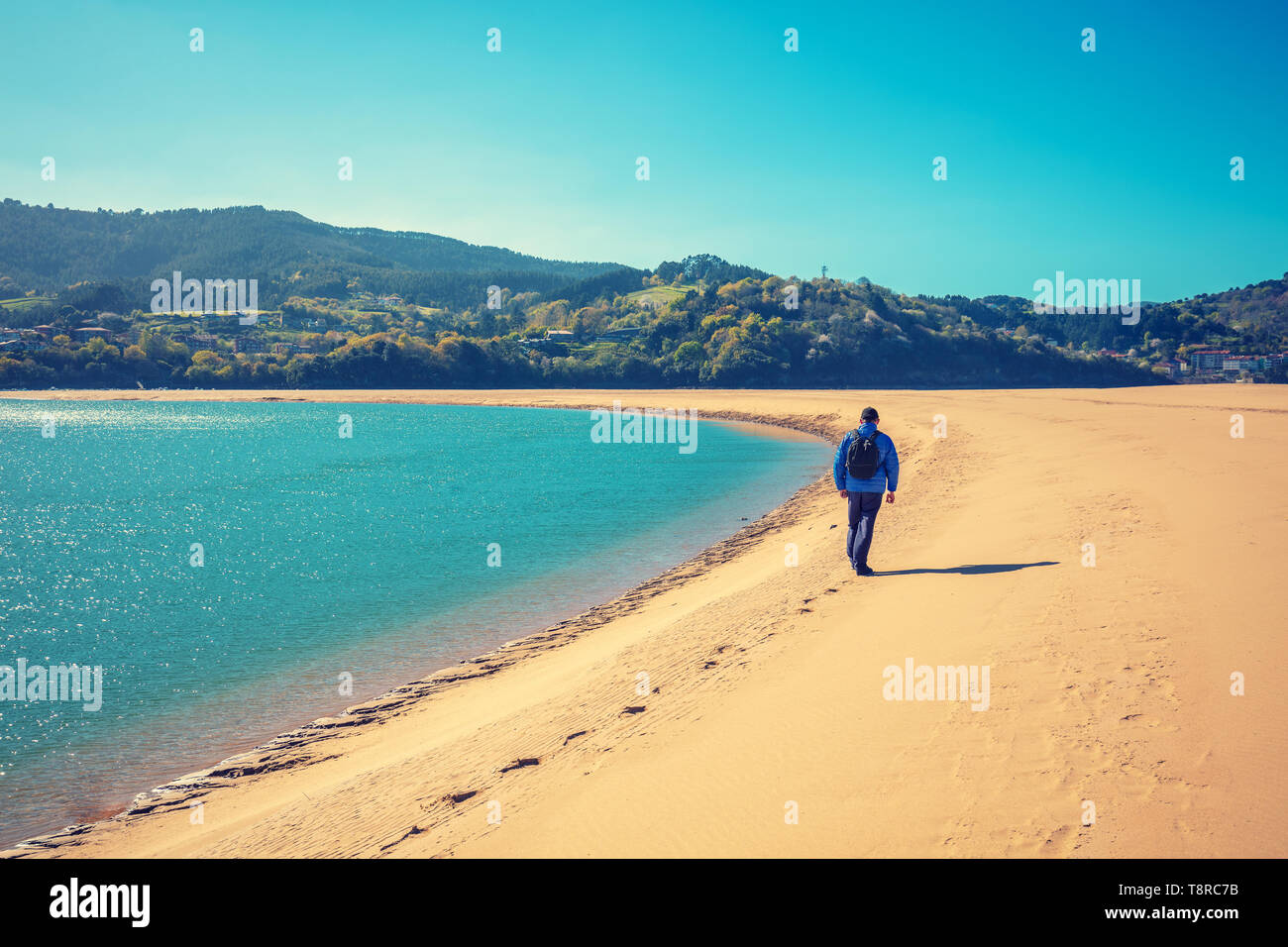 A man walks on the beach. Man looks at the sea Stock Photo