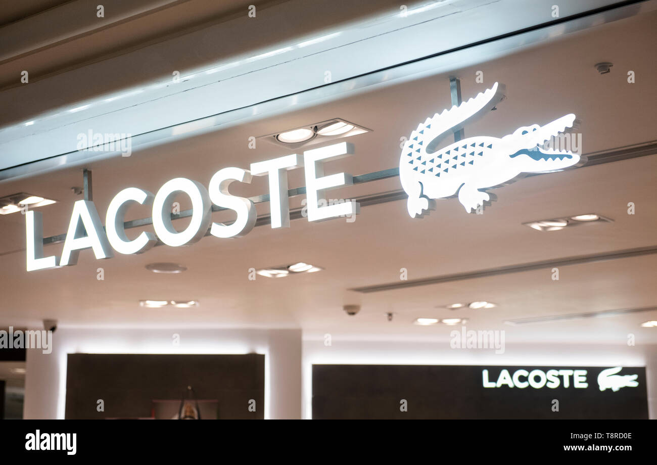French clothing brand Lacoste store and logo seen in Hong Kong shopping mall. Stock Photo