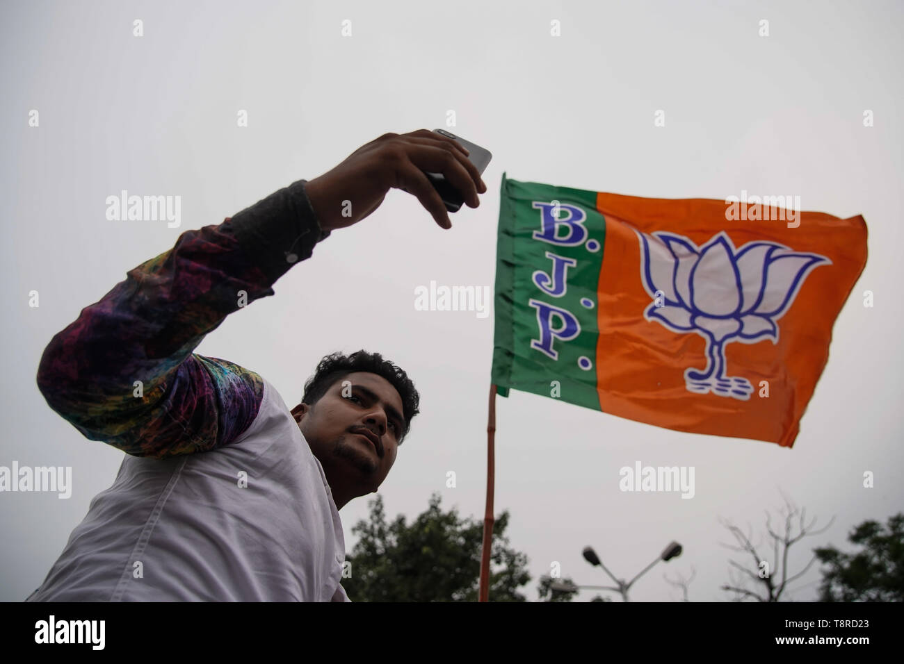 A Bharatiya Janta Party Or Bjp Supporter Seen Taking A Selfie While Holding A Flag During